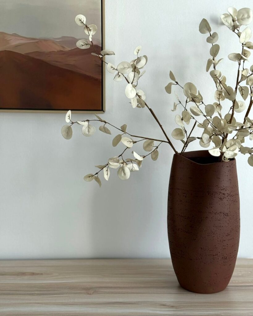 flower vase with picture frame in background